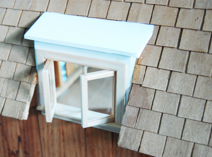 miniature double pane window with the panes of glass opened outward.